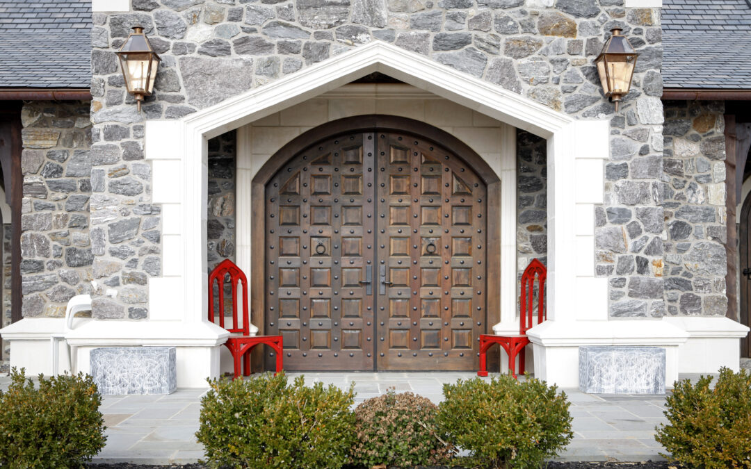 dark colored luxury custom door sitting amidst stone siding